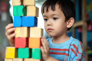 Child building a block tower
